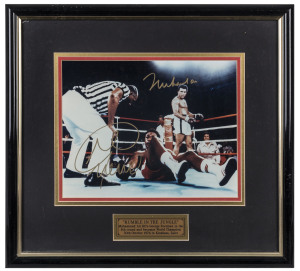 "RUMBLE IN THE JUNGLE" Ali and Foreman signed photograph capturing the moment in the 8th Round when Forman was Knocked-out and Muhammad Ali became World Champion again. Framed & glazed; overall 37.5 x 40cm. With CoA.