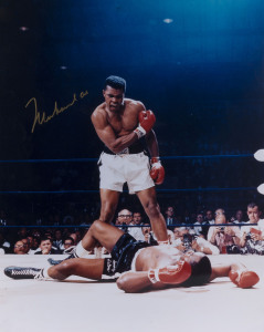 MUHAMMAD ALI, signed colour photograph of Ali standing over Sonny Liston, size 41 x 51cm.