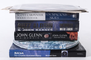 AMERICAN ASTRONAUTS AND THE SPACE RACE A small collection of signed books with the autographs of some of the most important early astronauts, without some of whom the June 1969 Moon Landing would not have been possible. The collection comprises "For Spacious Skies - The Uncommon Journey of a Mercury Astronaut" signed by SCOTT CARPENTER; "NASA The Complete Illustrated History" with a loosely inserted card signed by JOHN GLENN; "One Small Step - 40th Anniversary of the Race to the Moon" with a