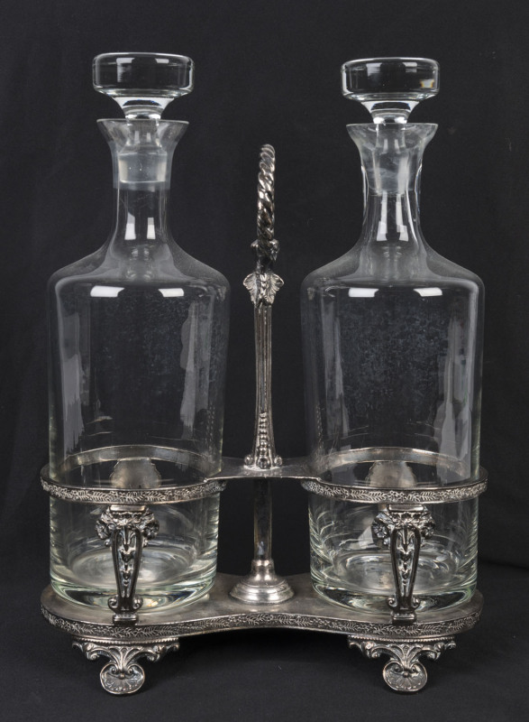 An English two bottle tantalus, silver plated by Walker & Hall, circa 1900, ​decanters later and not associated,