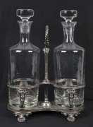 An English two bottle tantalus, silver plated by Walker & Hall, circa 1900, ​decanters later and not associated,