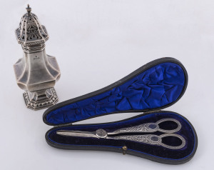 A pair of boxed sterling silver grape scissors by William Hutton & Sons, Sheffield, 1905; together with a sterling silver sugar caster made in London in 1919,