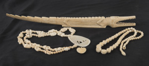 Two Chinese carved ivory necklaces, and ivory heart pendant and an African carved hippo's tooth crocodile, early to mid 20th century