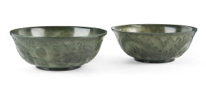 A pair of Chinese carved spinach jade dragon and pearl bowls, Qing Dynasty, 19th century,