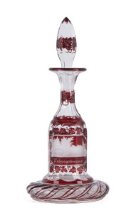 A Bohemian ruby overlay scent bottle with intaglio cut architectural scenes, circa 1860,