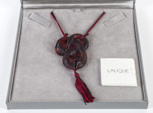 LALIQUE "Serpent" red frosted glass pendant on silk cord in original box with papers, signed "Lalique",