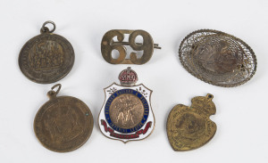 A fine WW1 badge showing an A.I.F. rising sun crest on an oval-shaped filigree field (marked "STERLING/MADE IN PALESTINE" on reverse); also a Returned Sailors & Soldiers Imperial League Australia badge (by Stokes of Melbourne); a 1902 Coronation badge (Hawthorn), a 1937 Coronation badge (Victoria), and 2 other items. (6).