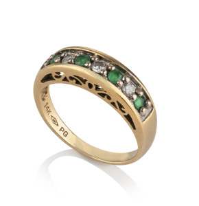 A 14ct yellow gold ring set with emeralds and diamonds, stamped "14K, PG",