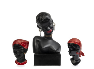 Ceramic Negress bust on timber stand and two wall busts, mid 20th century,