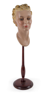 An Art Deco shop display bust, painted plaster on turned wooden stand, circa 1930,