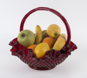 A Fenton ruby glass fruit basket and fake fruit, 20th century,
