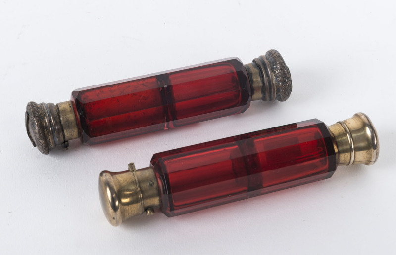 Two ruby glass double ended scent bottles with silver lids, 19th century,