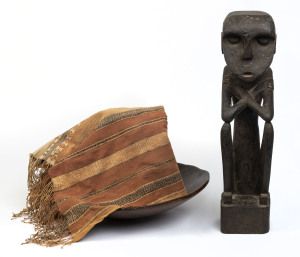 A carved wooden bowl, Tiwi Islands; carved wooden seated figure, an Indonesian wooden bowl and antique Indonesian textile,