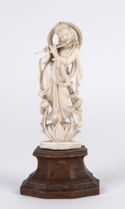 An Indian ivory statue of Krishna on wooden plinth, early 20th century,