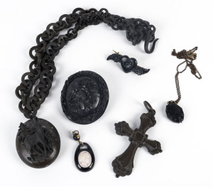 Jet and bog oak jewellery including finely carved brooches, crucifix and pendants, 19th century,