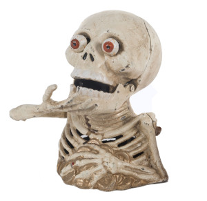 An American skeleton money box, painted cast iron,