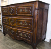 An early 18th century French walnut commode with serpentine front, unusual drawer configuration with the top bank divided into three drawers, - 2