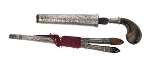 A flint with finely carved wooden handle in scabbard together with a pair of daggers in silver scabbard, 19th century, 21cm and 22cm long
