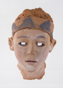 A terracotta facemask with blue painted highlights, 28cm high