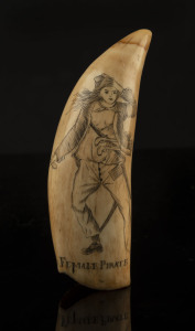 A scrimshaw whale's tooth titled "Female Pirate", ​13.5cm high