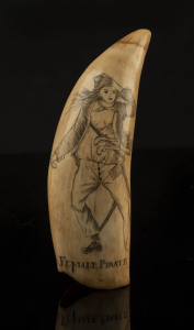 A scrimshaw whale's tooth titled "Female Pirate", 13.5cm high