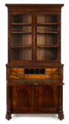 A fine Colonial secretaire bookcase with turned columns and cross-banded edging, N.S.W. circa 1840, interior fitted with satinwood fronted drawers and compartments, 229cm high, 112cm wide, 57cm deep