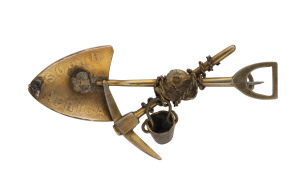 A goldfields brooch, pick and shovel with rope and bucket and nuggets,