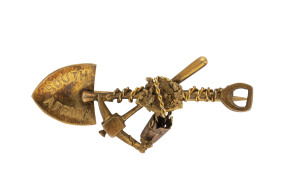 A gold miner's brooch with pick, shovel, rope and nuggets, marked "9ct, South Africa"