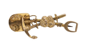 A goldfields brooch, crossed pick and shovel entwined with rope and adorned with nuggets, stamped "18ct", 5cm long, 6.5 grams