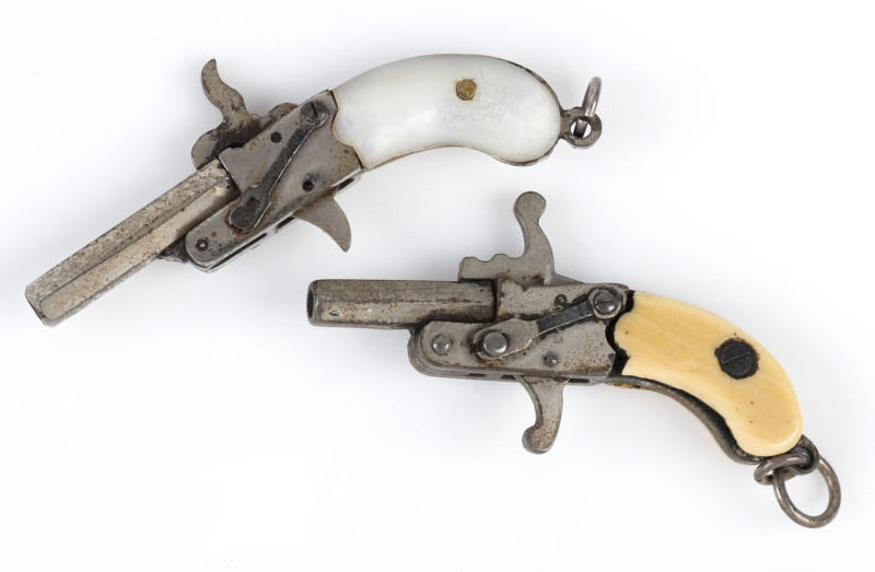 Two miniature flintlock style pistol fobs with working mechanisms, one stamped "Germany", 19th century, 4cm and 4.5cm long