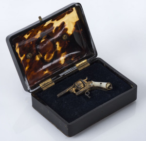 A miniature antique revolver fob in a fitted tortoiseshell case with gold plaque named "SIR E. MALTMAN", 19th century, case 8.5cm across