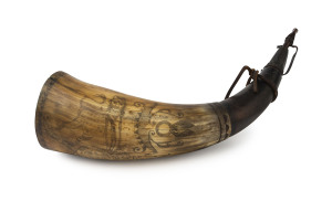 A scrimshaw powder horn with lion and coat of arms, 19th century, 30cm long