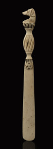 A whalebone page turner with carved dog handle, 19th century, ​24cm high