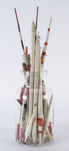 A collection of antique and vintage fishing floats in a glass jar, 19th and 20th century, the largest 48cm high