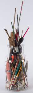 A collection of antique and vintage coloured fishing floats in a glass jar, 19th and 20th century, the largest 45cm high