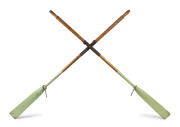 A pair of antique dinghy oars with green painted finish and leather mounting, late 19th century, ​245cm long