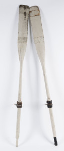 A pair of dinghy oars with white painted finish, 19th/20th century, old metal strap repairs to blades, 184cm long