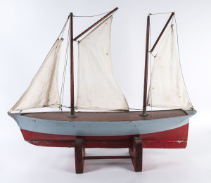 A vintage pond yacht with sails, circa 1930, 90cm long