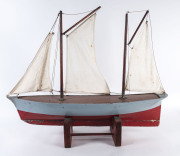A vintage pond yacht with sails, circa 1930, ​90cm long