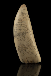An impressive scrimshaw whale's tooth engraved with shipping route from England to Australia, on later wooden stand, tooth 22cm high