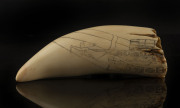 An impressive scrimshaw whale's tooth engraved with shipping route from England to Australia, on later wooden stand, ​tooth 22cm high - 2