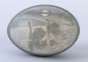 A carved emu egg with swans and cygnets, 19th century, 12.5cm wide.