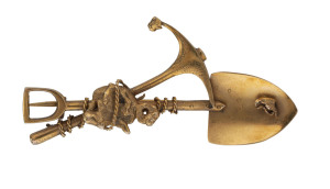 A gold miner's brooch crossed pick and shovel with rope and nuggets, stamped "9ct",