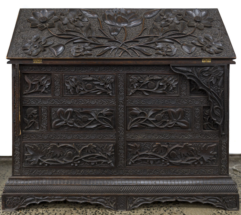 A fine Anglo-Indian bureau ornately carved with opium poppies and flowers, padauk, early 19th century, ​88cm high, 95cm wide, 50cm deep