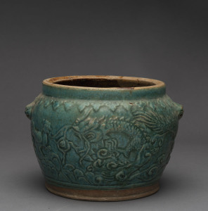 A Chinese earthenware pot with jade green glazed dragon motif, 19th century 17cm high