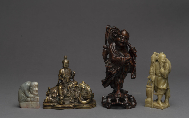 Four assorted Chinese figures, ​brass, stone and timber, 20th century, the tallest 20cm high