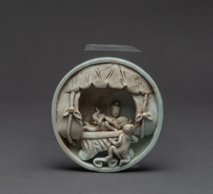 A Chinese porcelain erotic plaque, possibly Ming, 11cm diameter