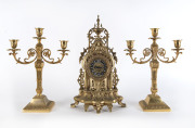 A German gilt metal clock and pair of three branch candelabra, mid 20th century, ​the clock 42cm high