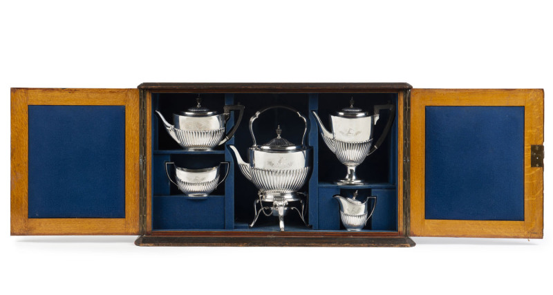 TEESDALE SMITH Family sterling silver tea service, maker's mark "E.H.", London, circa 1888, engraved with the family crest and motto, housed in original plush fitted oak cabinet box, with Sydney retailers plaque "FAVELLE & ROBERTS, SYDNEY". The cabinet 46