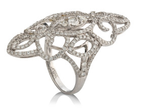 An 18ct white gold diamond set filigree dress ring with open faced marquise shaped top mount, stamped "750"